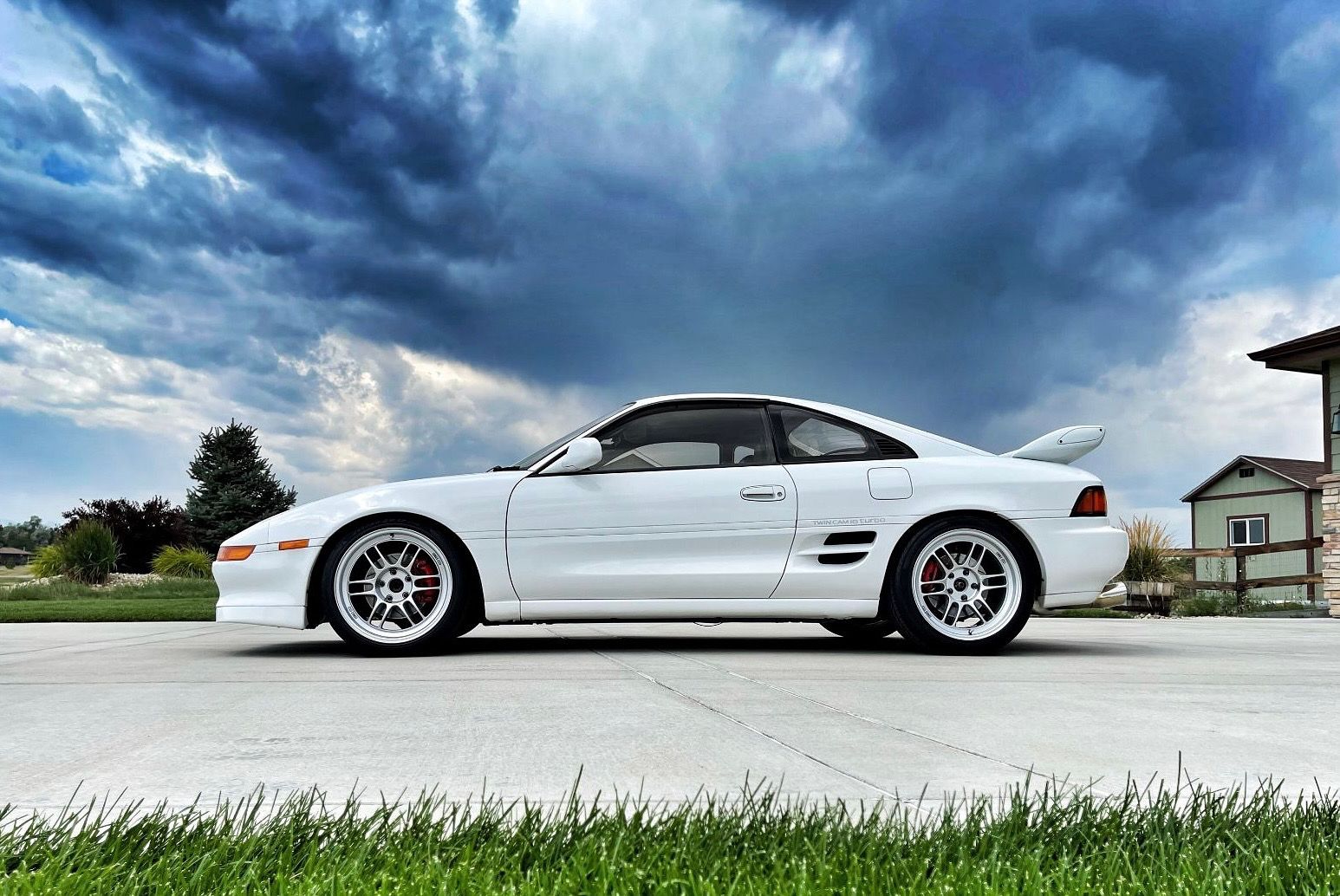 Brian's white Toyota MR2 in profile under a dramatic Colorado sky